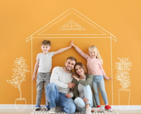 family picture with kids making a a house sign